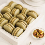 Green macarons are in the box.