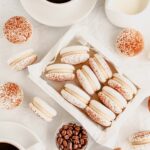 White macarons in the box on the table.