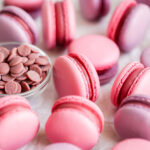 Pink and purple macarons on the table.