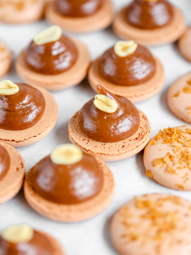 Chocolate ganache piped on the macaron shells.