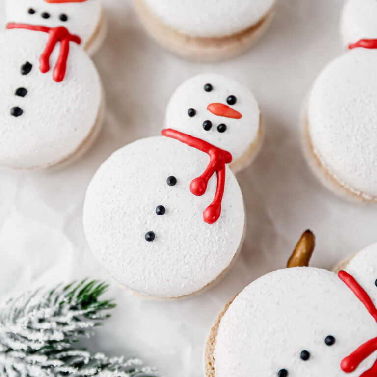 White macarons shaped like a snowman.