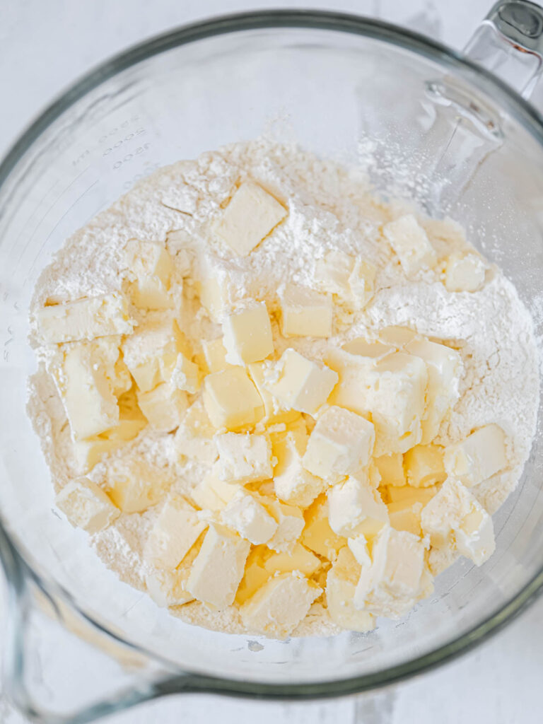 Dry ingredients and cubes of butter in the mixing bowl. 