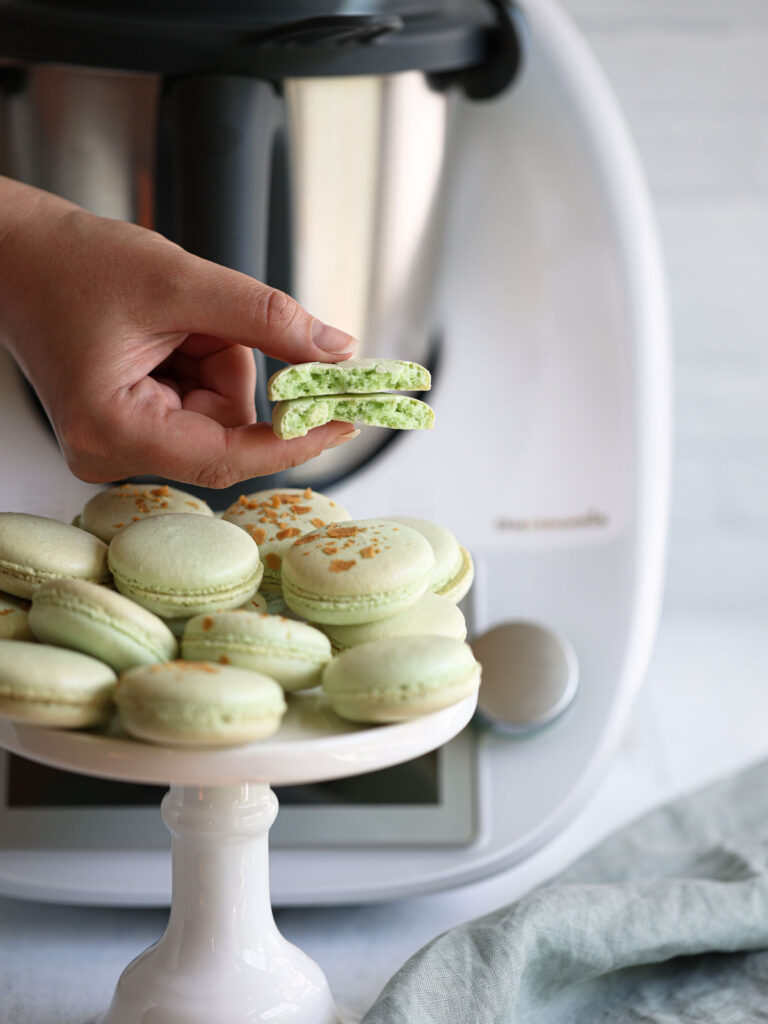 Hand holding macarons. 