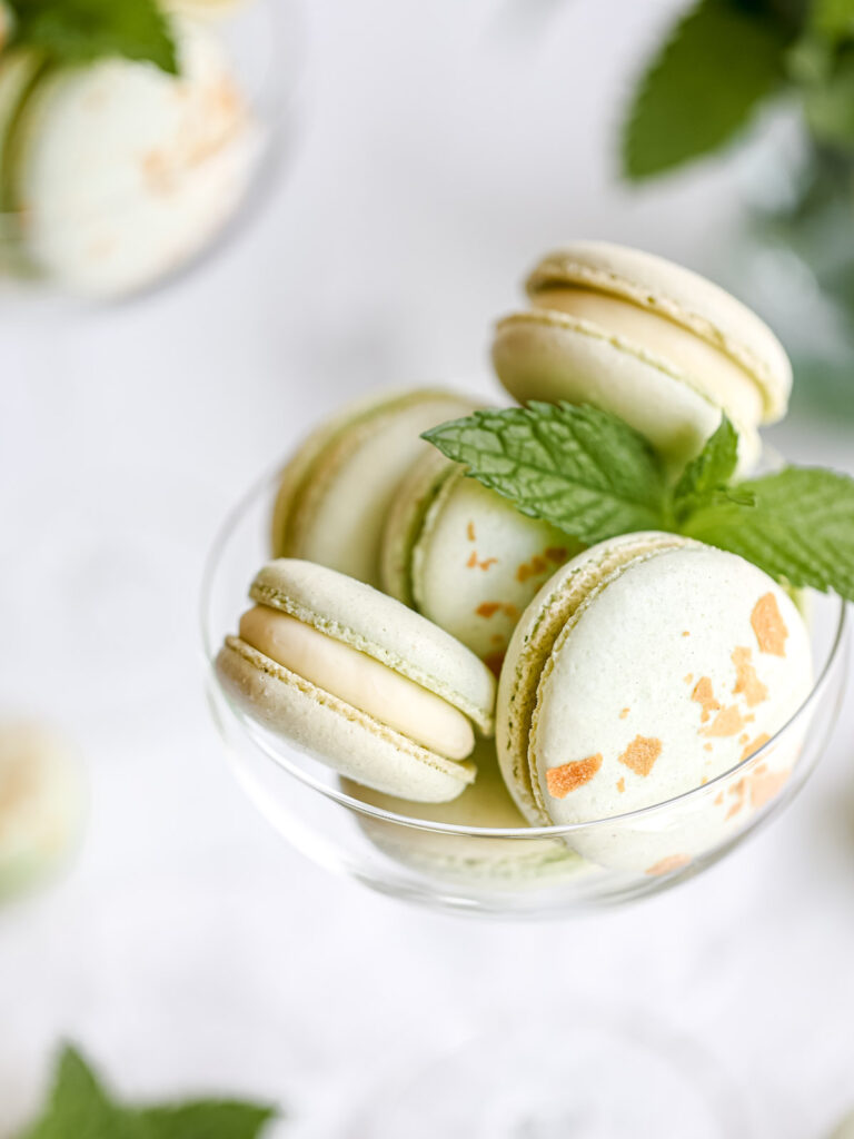 Green macarons with fresh mint in the martini glass. 