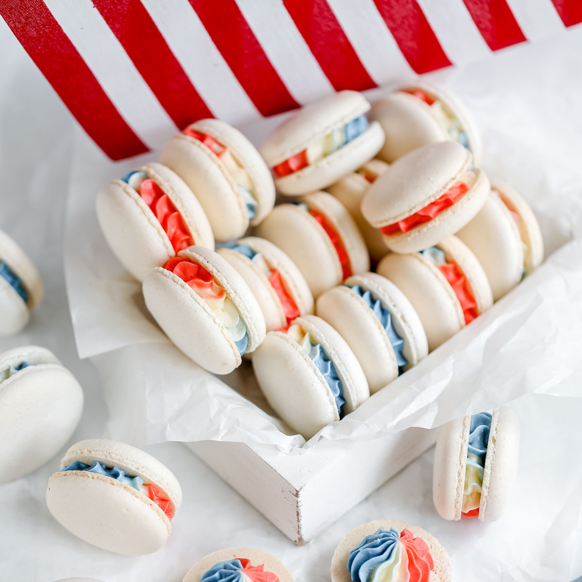 White macarons filled with red, white, and blue filling.
