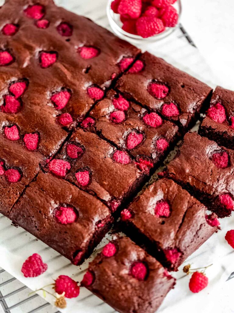 Chocolate brownies with raspberries cut into pieces. 