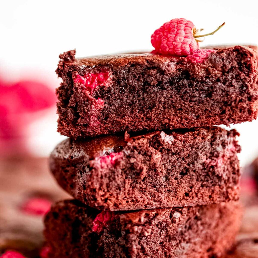 Chocolate brownies with raspberries cut into pieces.