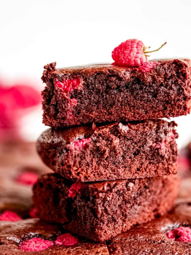Chocolate brownies with raspberries cut into pieces.