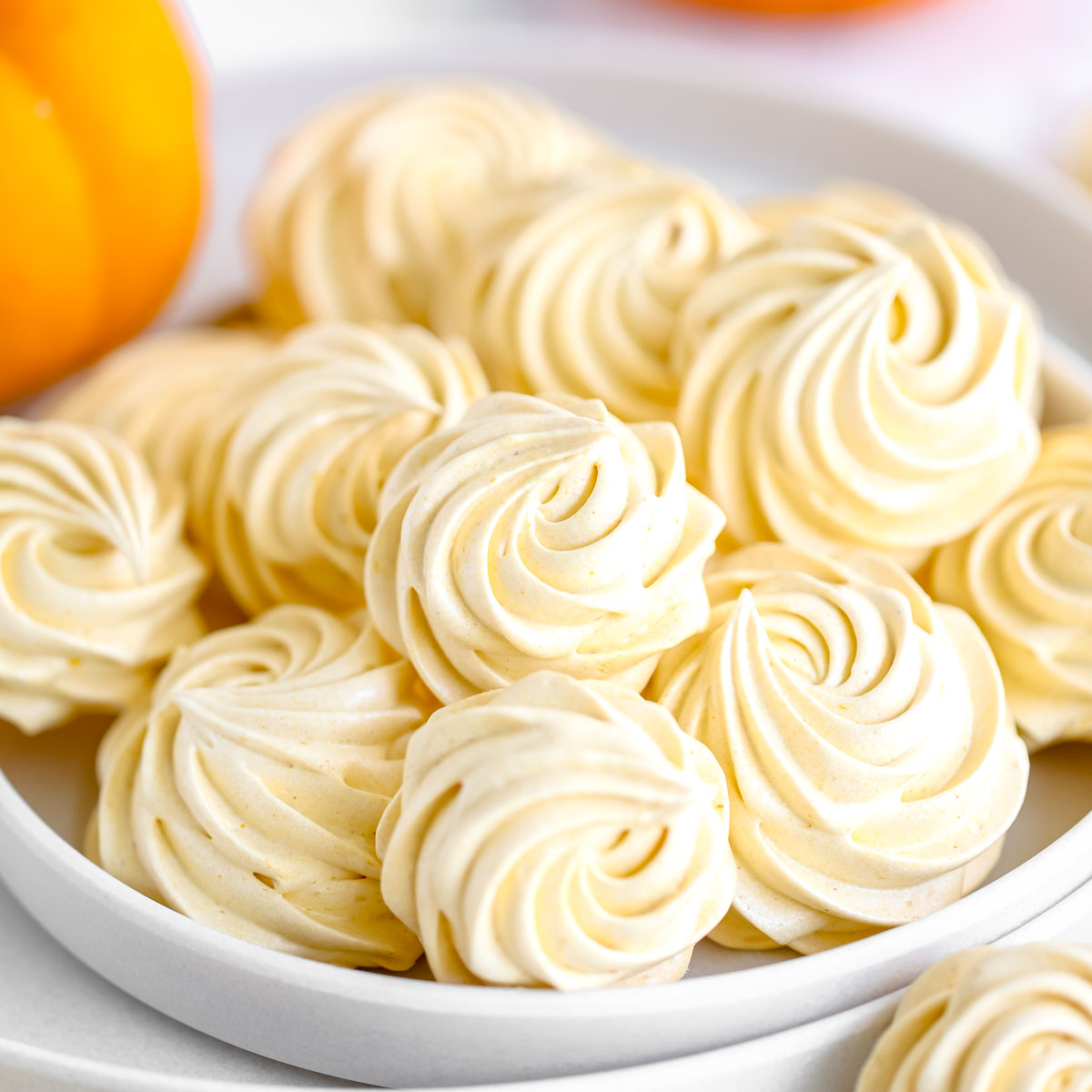 Orange marshmallows are on the plate.