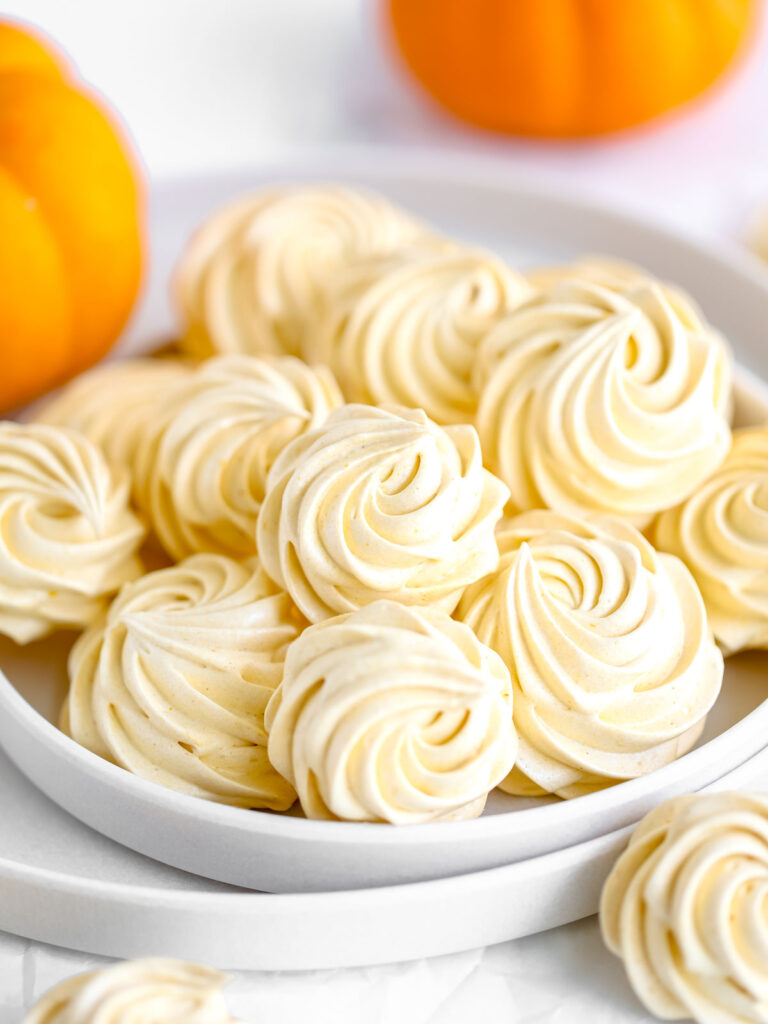 Orange marshmallows are on the plate. 