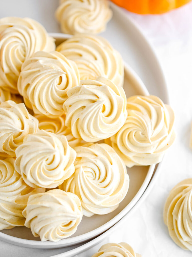 Orange marshmallows are on the plate. 