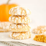 A stock of orange cookies is on the table.