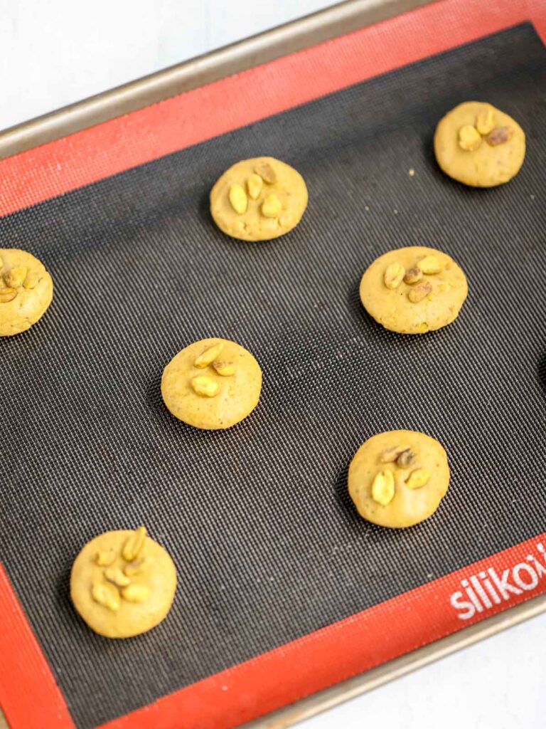 Pistachio cookies on the baking tray. 