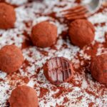 Chocolate Mascarpone Truffles with cocoa powder on the table.