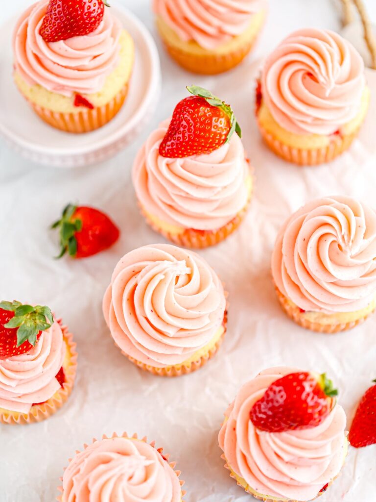 Cupcakes decorated with strawberry buttercream. 