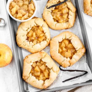 Mini apple galettes on the baking tray.
