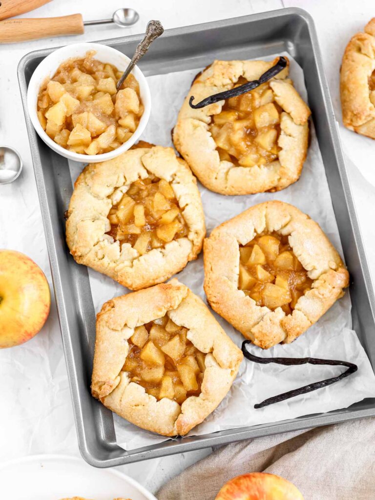 Mini apple galettes on the baking tray. 