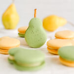 Yellow and green macarons are shaped like a pear.
