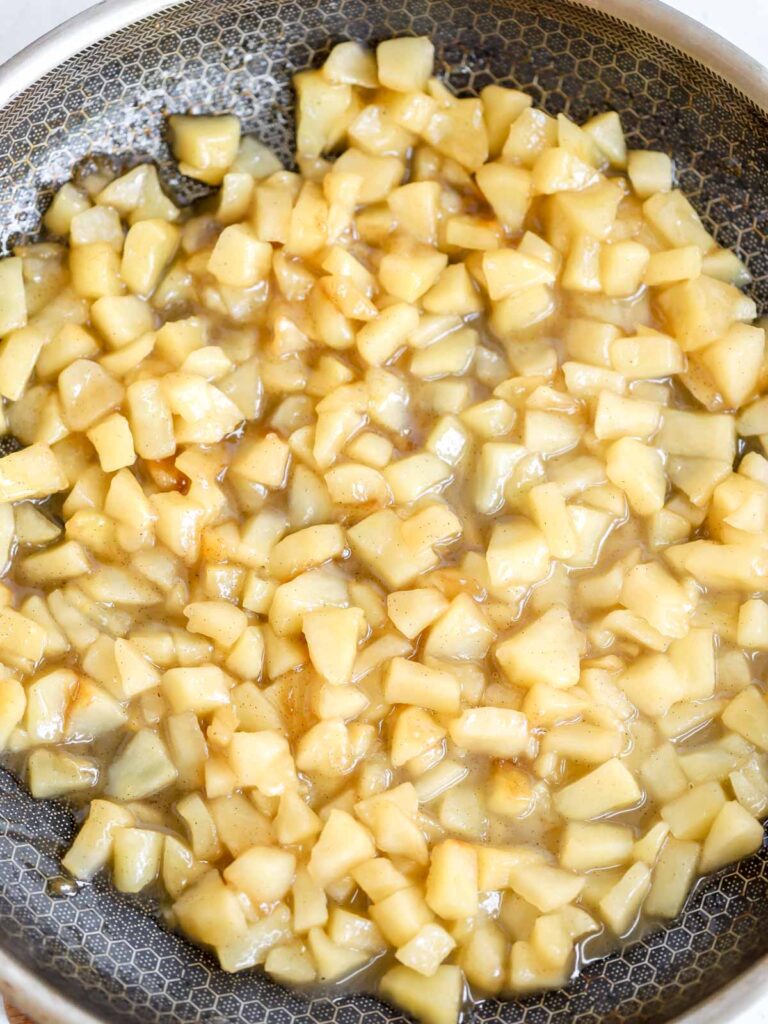 Cut apples in the frying pan. 