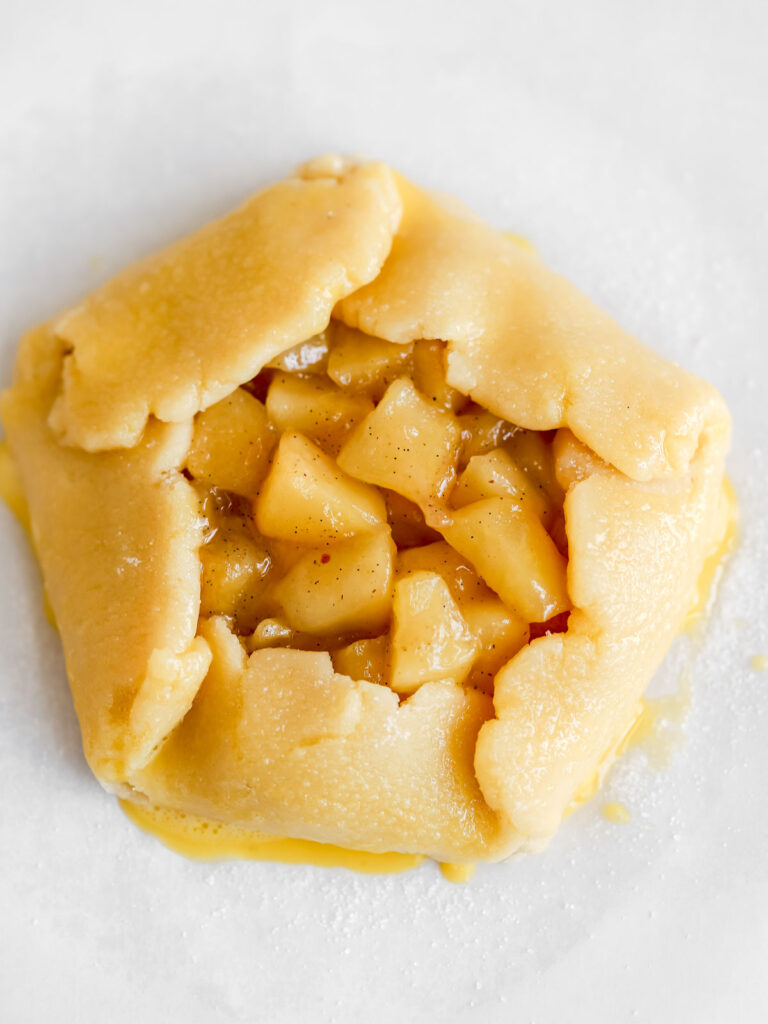 Apple galette on the parchment paper. 