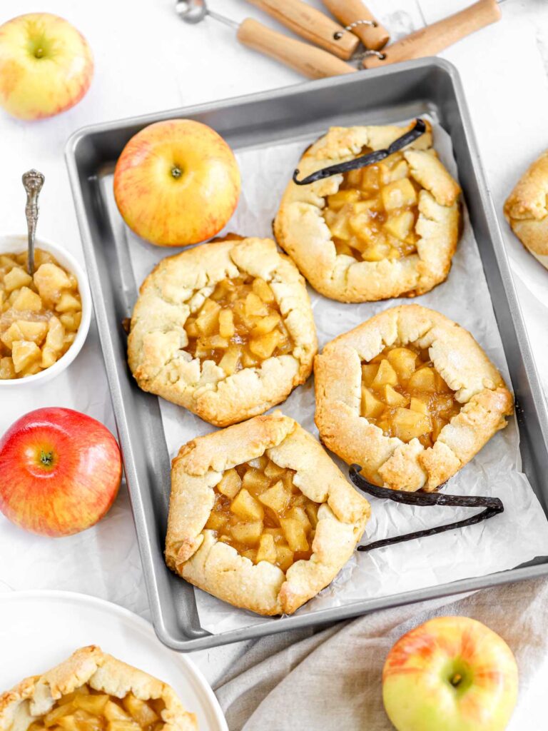 Mini apple galettes on the baking tray. 