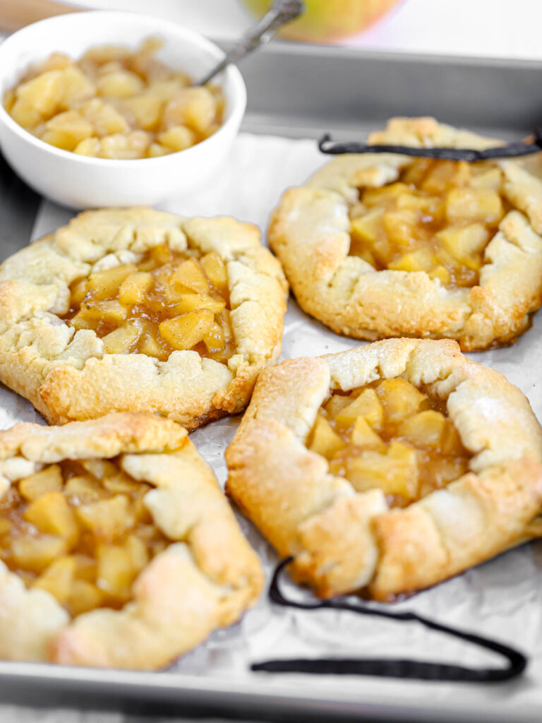 Mini apple galettes on the baking tray. 