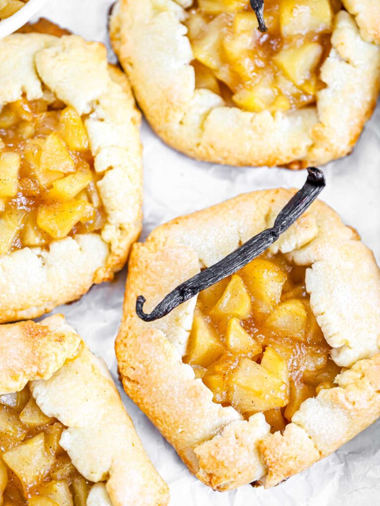 Mini apple galettes on the baking tray. 
