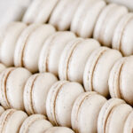 White macaron shells in the white box.