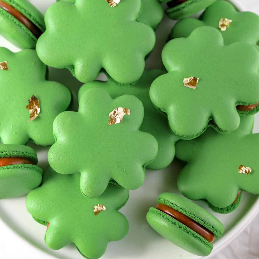 Shamrock shaped macarons on the plate.