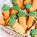 Carrot shaped macarons in the box.
