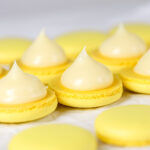 Ganache pipped on macaron shells.