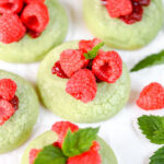Green Cookies decorated with fresh raspberries.