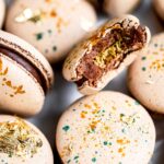 Chocolate macarons with edible gold.