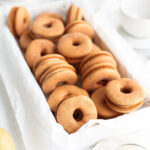 Donut-shaped macarons are in the box.