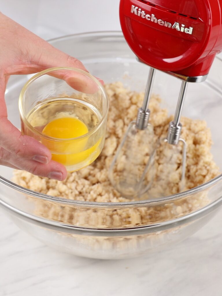 Adding egg to cookie butter. 