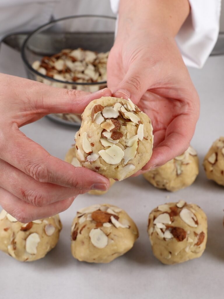 Hans is holding a cookie ball. 
