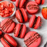 Red macarons filled with dark chocolate ganache
