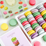 Laduree book and macarons on the table.