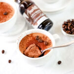 Espresso mousse in the white cup with the spoon.