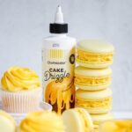 Cupcakes and macarons decorated with yellow ganache.