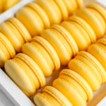 Yellow mango macarons in the white box.