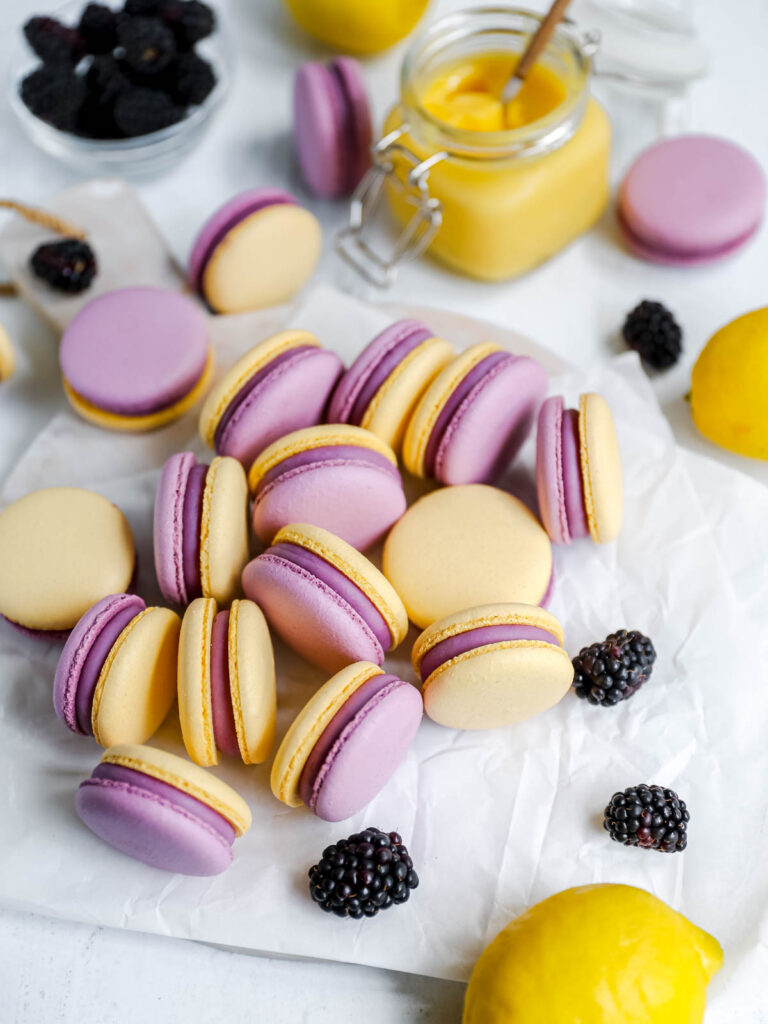 Purple and yellow macarons on the table.