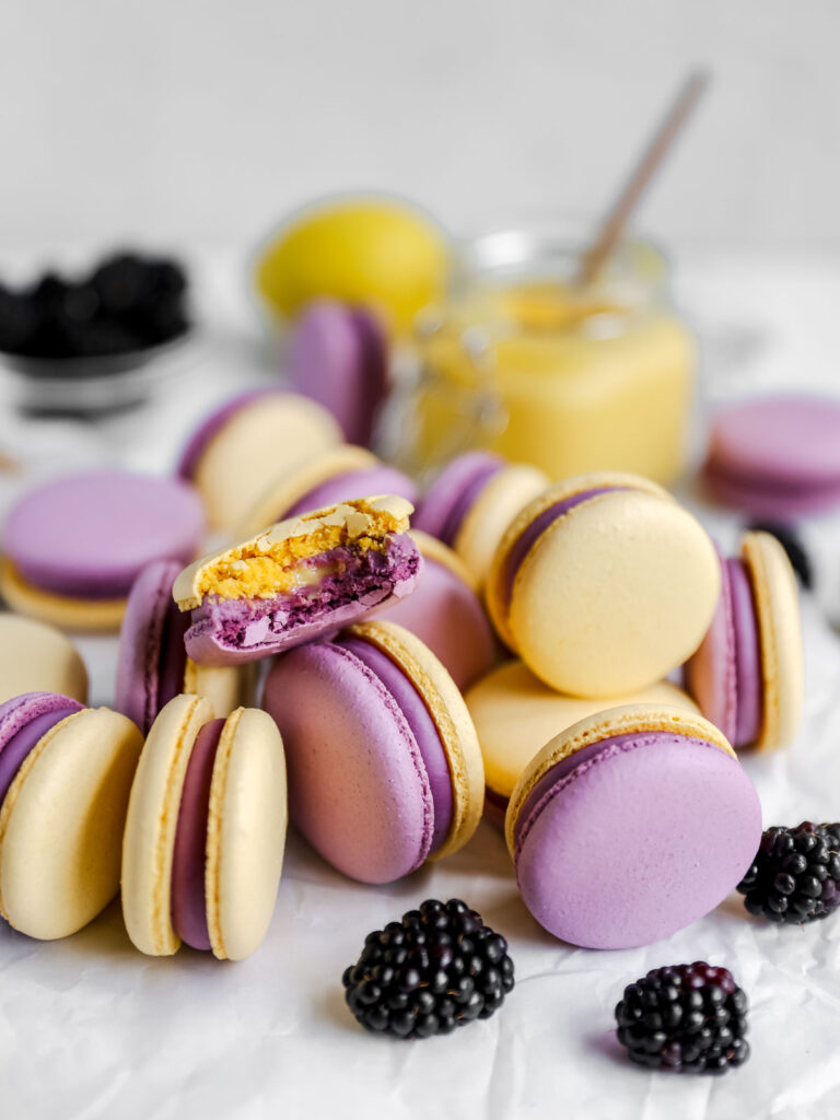Purple and yellow macarons on the table. 