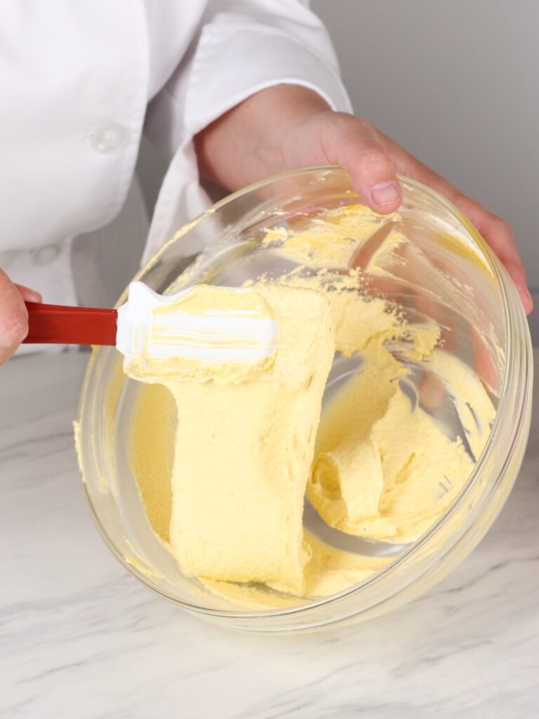 Yellow macaron batter in the mixing bowl. 