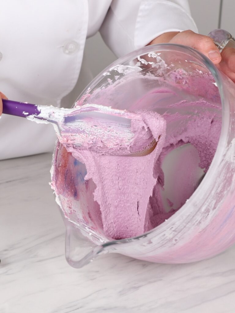 Purple macaron batter in the mixing bowl. 