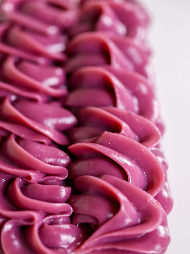 Blackberry ganache piped on the plate. 