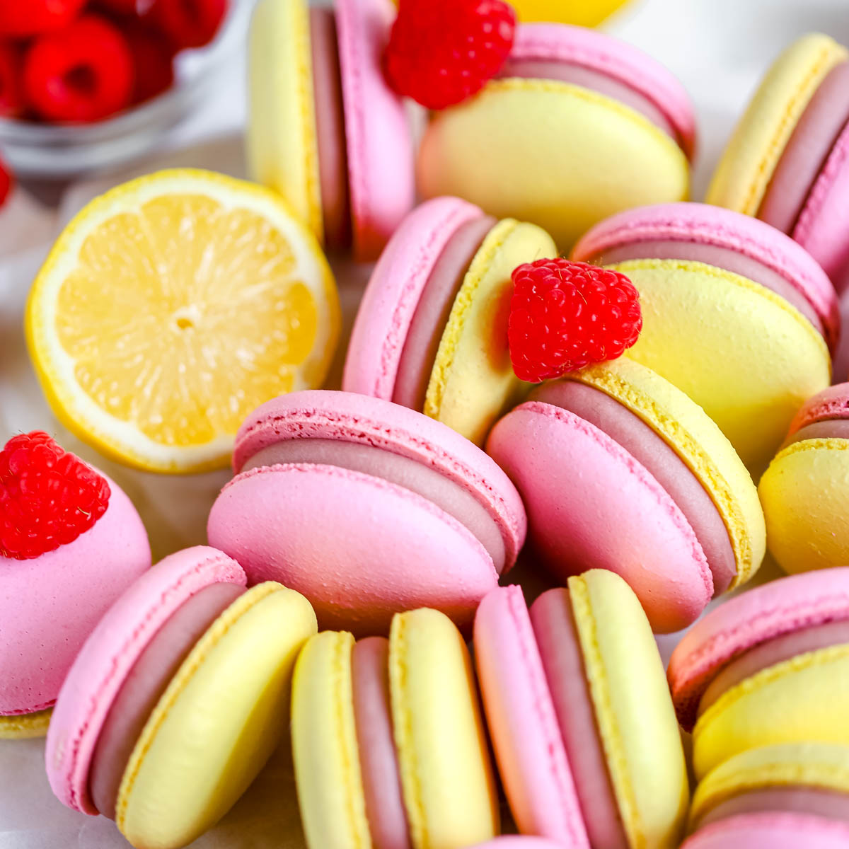 Pink and yellow macarons on the table.
