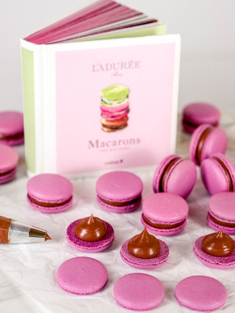 Ladurée macarons book with macarons on the table. 