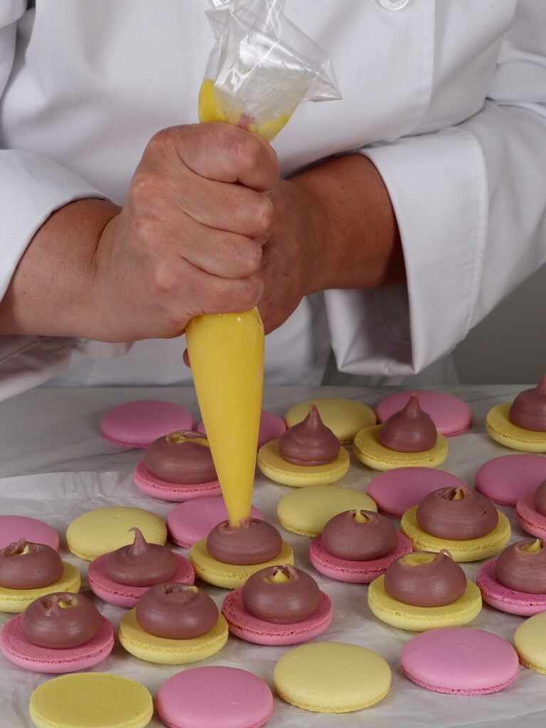 Piping lemon curd in the ganache. 