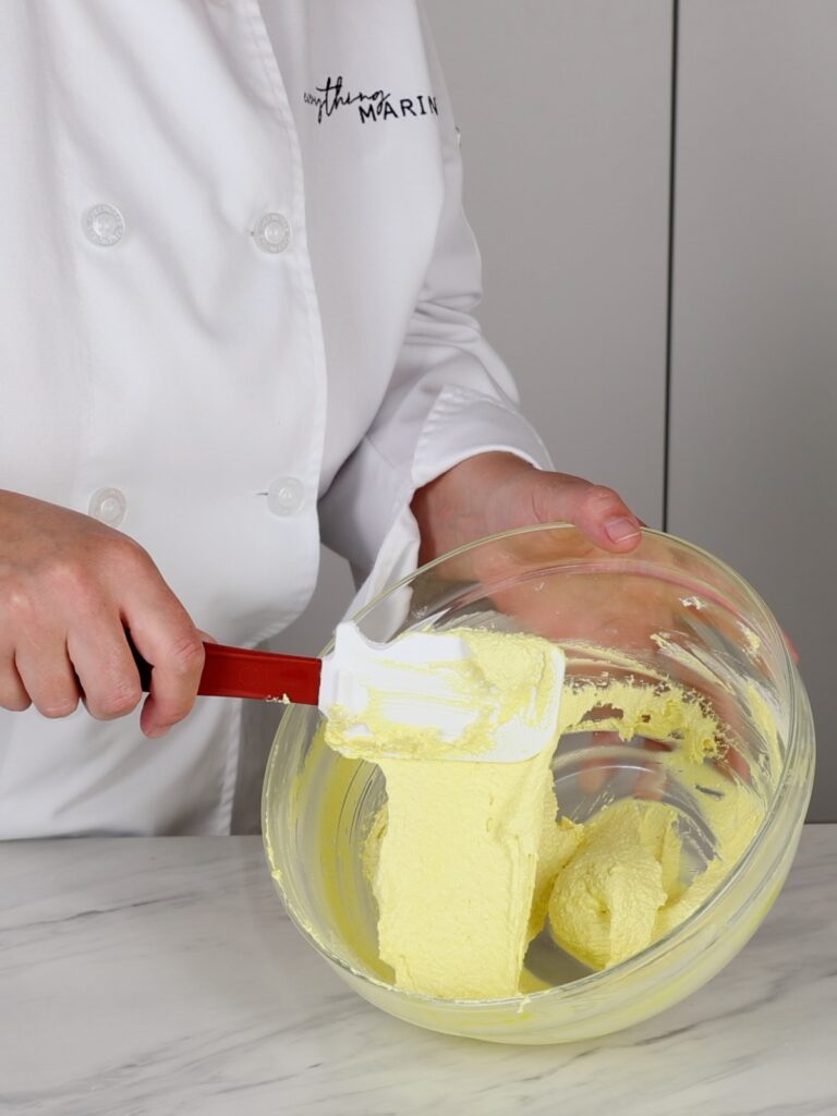 Yellow macaronage in the mixing bowl. 